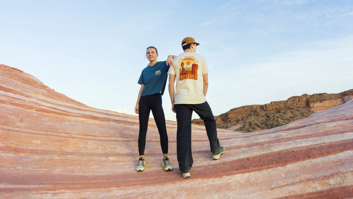 Two people in the desert in The Landmark Project tees