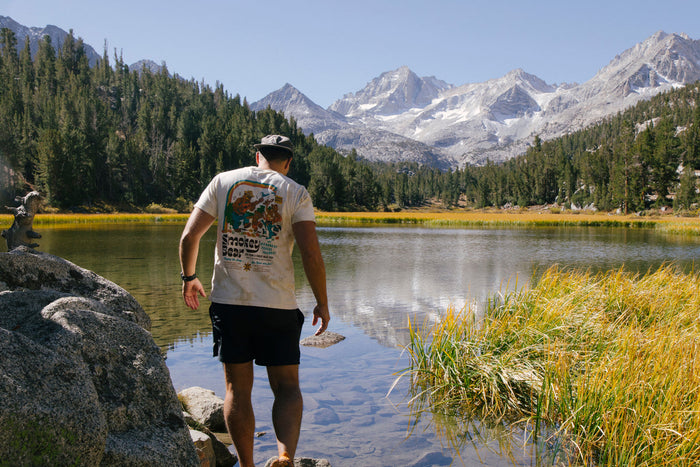Man wearing a Smokey Band Tee in the mountains