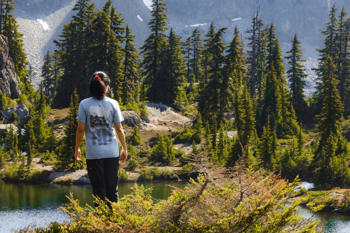 Woman standing outside in a Landmark tee