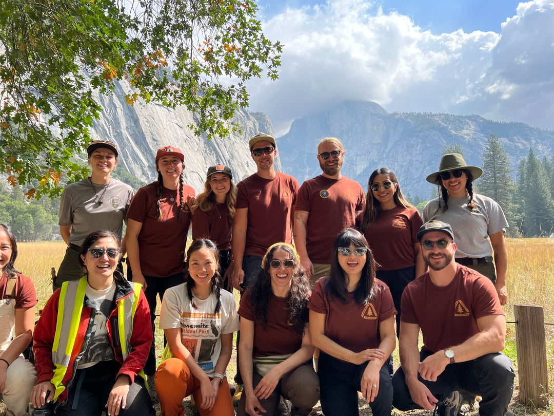 Group of people standing together in Yosemite National Park after doing volunteer work that helps in the preservation and conservation of the environment.